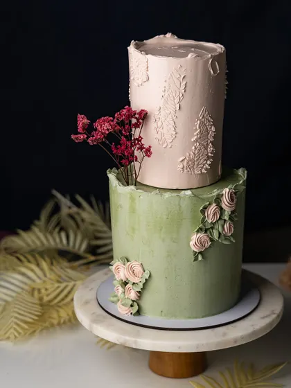 This two-tiered cake showcases the beautiful textures and floral arrangements you'll learn to create. The class focuses on color palette theory and working with both real and dummy tiers for practice.