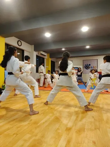 A view of our senior students demonstrating advanced kata forms during a training session. The focus is on precision, power, and posture, key elements of the Karate Budokan International style we teach.
