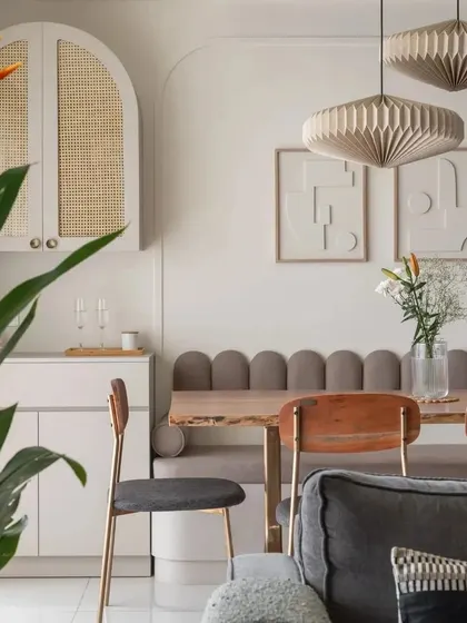 A sleek crockery unit with curved lines that echo the wall's gentle contours. The wicker shutters add a touch of organic elegance, balancing transparency with style.