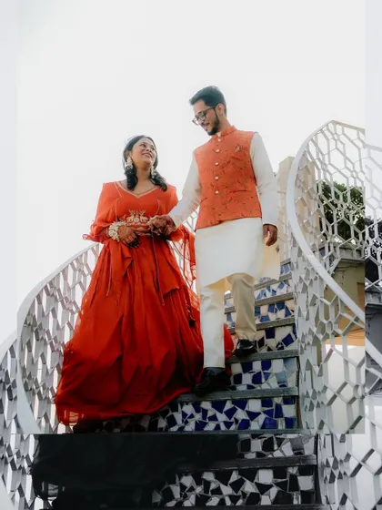 Walking down the stairs together, hand in hand. This shot of Sugandha and Ashish is a beautiful metaphor for the start of their new journey, captured with artistic flair.