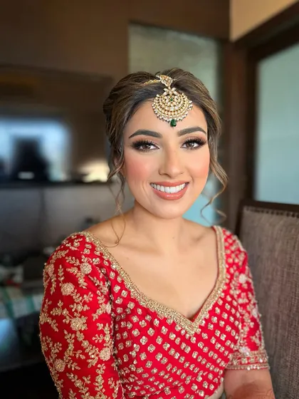 The joy on a bride's face is my greatest reward. For Jasmeet, I crafted a radiant bridal look with soft, defined eyes and a warm, glowing complexion that perfectly complemented her traditional red lehenga.