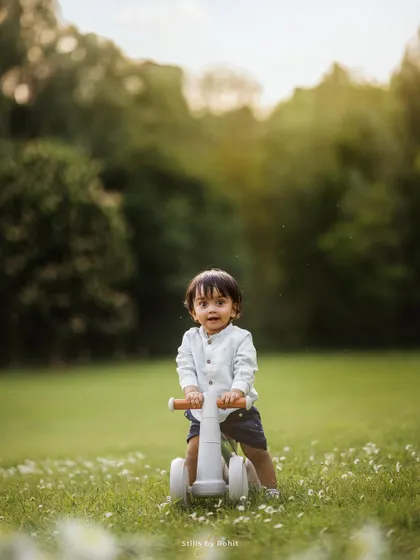 The fun begins at one! A baby boy enjoying his first ride in the park. First birthday shoots are a wonderful way to celebrate this huge milestone.