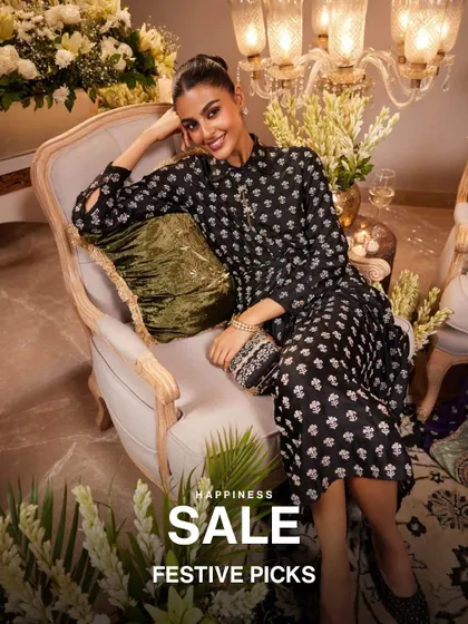 My festive picks are on sale. This model looks stunning in a black printed kurta, holding an embellished clutch, showcasing a perfect look for a Diwali party or wedding reception.