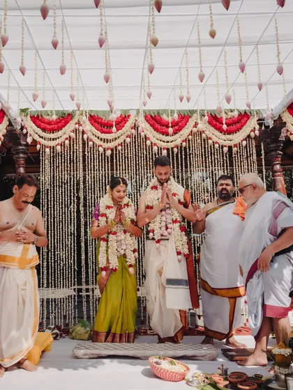 The couple stands together during the Muhurtham, surrounded by priests and family. Our planning ensures that these core traditional moments are the central focus of the day.