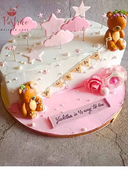 A lovely half-birthday cake for a baby girl, with a "half and half" design featuring teddy bears and stars.