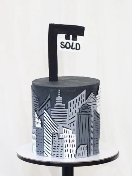 Another view of my real estate-themed cake. The hand-painted skyline detail and bold "SOLD" sign make it a perfect centerpiece for celebrating a successful deal or a corporate milestone in the property sector.