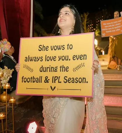 A fun and personalized bridal entry. The bridesmaids hold up cute and funny signs with vows, adding a unique and personal touch to her walk down the aisle.