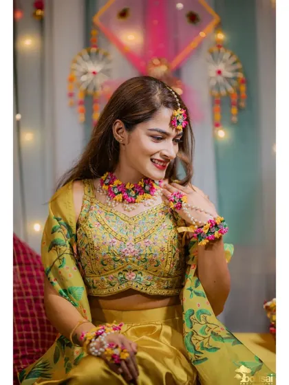 A beautiful portrait of the bride at her Mehndi and Haldi ceremony, adorned with floral jewelry.