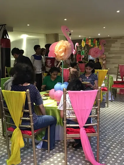 A wider view of the birthday celebration, showing the vibrant table settings and happy guests. My goal is to create a festive atmosphere where everyone, hosts included, can enjoy the party.