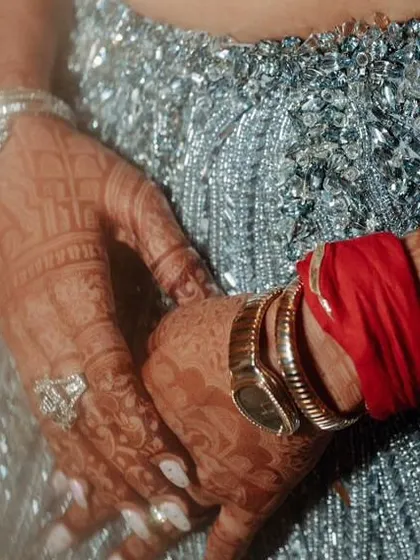 A detail shot of Nikita's sangeet look, showing the intricate silver beadwork on her lehenga and her diamond-studded bracelets.