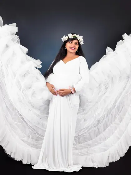 Another stunning shot from our maternity package, featuring the white angel wing gown in our studio.