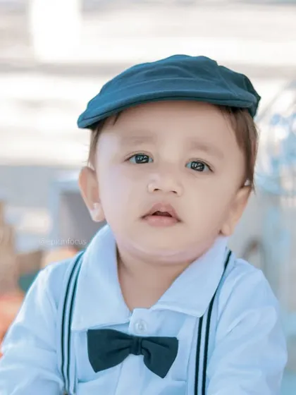 A classic, handsome portrait of a little boy in a newsboy cap. The soft, natural light of the outdoors creates a beautiful, gentle quality in the photos.