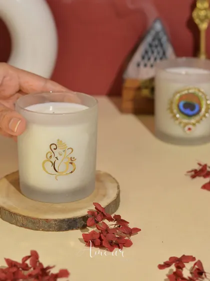 A closer look at the elegant frosted glass 'Shri Ganesha' candle, a symbol of hope and good luck for the New Year.