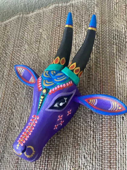 The purple Nandi against a neutral textured background, showing how its vibrant colors can stand out and become a focal point.