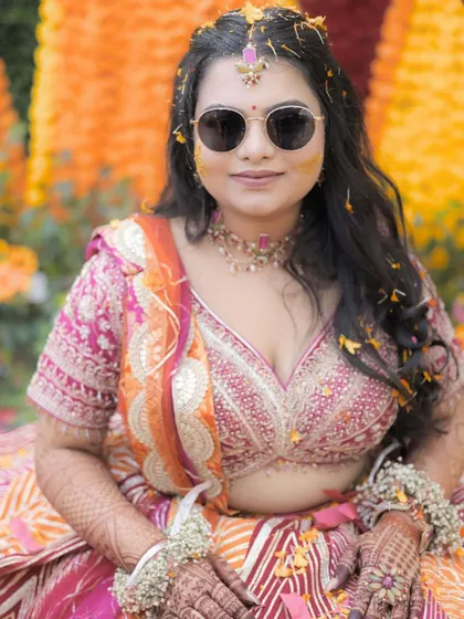 Another beautiful close-up of the bride. Her makeup is designed to be subtle and long-lasting, perfect for the fun and messy Haldi ceremony.