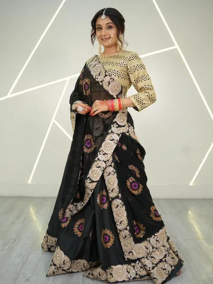 A full shot of the stunning black and gold embroidered saree, perfect for a traditional wedding.