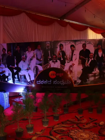 The main photo backdrop for the Zee Kannada event, featuring prominent branding and a collage of the channel's stars, set against a professionally lit stage.