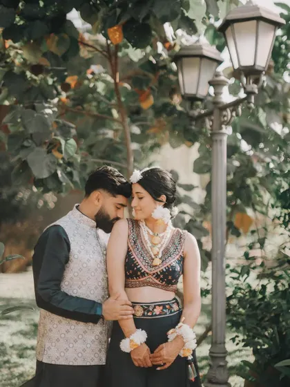 A quiet, romantic moment between Rahul and Anjali in a garden setting. The soft, natural light is perfect for capturing tender interactions.