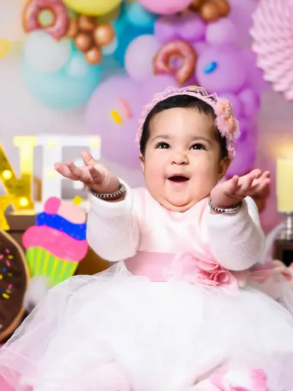 After the messy fun, we get a clean and happy portrait. Prisha is all smiles in her beautiful pink and white dress, celebrating turning one.