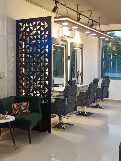A view of the styling stations from the waiting area. The open design still feels intimate thanks to design elements like the partition and strategic placement of furniture.