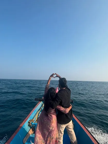 A couple making a heart shape with their hands against the ocean backdrop. It's these sweet, simple moments that make our mid-sea experiences so special.