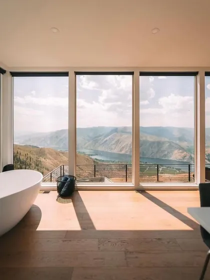 This bathroom feels like a spa, with a freestanding tub positioned to take full advantage of the stunning valley view. It's a perfect example of luxury meeting nature.