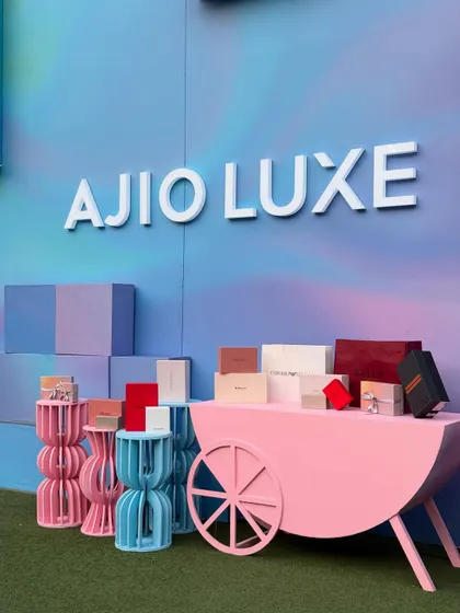 The Ajio Luxe branding stands out against the dreamy, airbrushed background. This setup was designed to attract attention and provide a perfect photo opportunity for guests at the luxury weekend event.