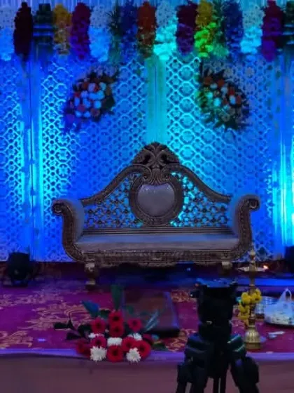 A simple reception backdrop with blue and green lighting effects. The elegant sofa provides a beautiful focal point for the couple.