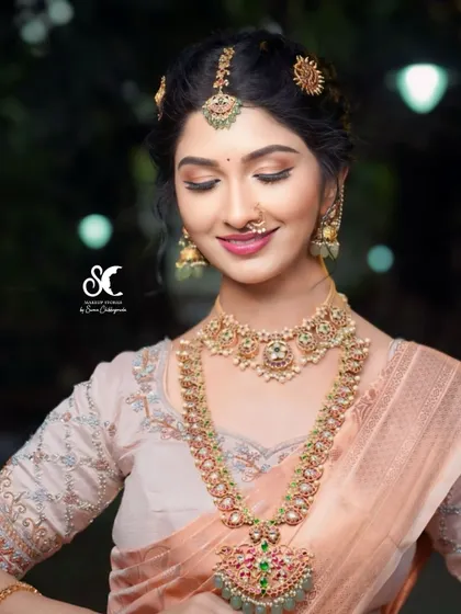 A model styled for a Ganesha Habba photoshoot, wearing a beautiful Navratna-style choker and haram set.