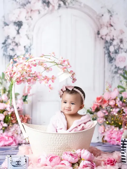 A beautiful portrait from a six-month milestone session. The elaborate floral setup and cute bathrobe make this a truly unique and memorable photo.