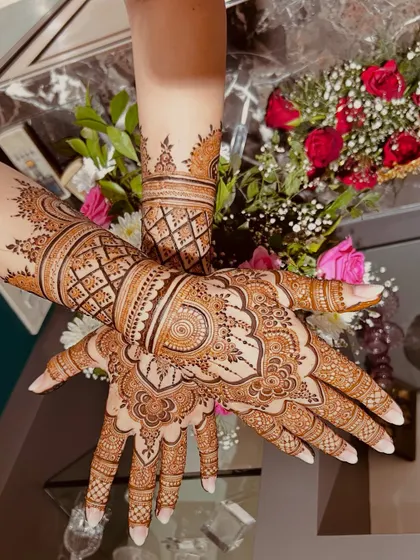 A gorgeous, full-coverage design with a mix of geometric and floral patterns. The symmetry between the two hands is just perfect.