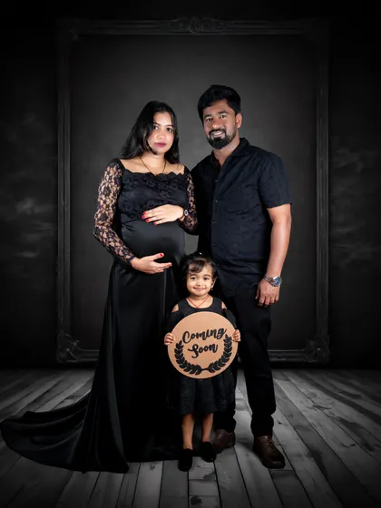 A dramatic and elegant maternity portrait from our studio. We work with expecting parents to create powerful images that celebrate this special time, offering styling assistance and a range of gowns to achieve the perfect look.