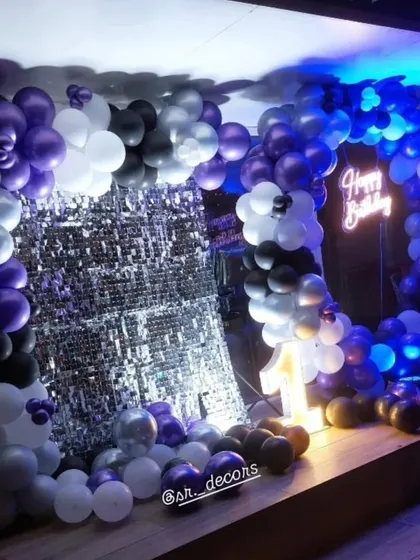 A closer view of the shimmer wall and balloon ring, showing the light-up number '1' for a chic first birthday party.