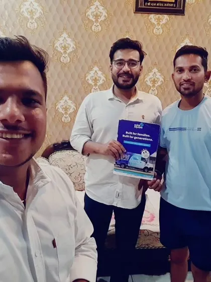 Our team takes a selfie with new customers holding our solar guide.