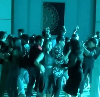 The dance floor is lit in cool blue at the Appario party.