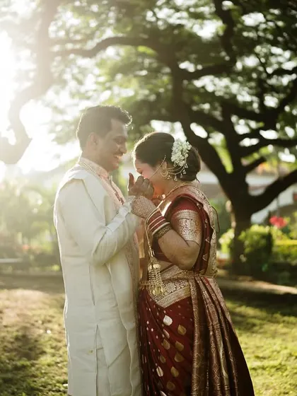 Bathed in the golden hour light, this intimate moment captures the couple's tender connection in a beautiful garden setting.
