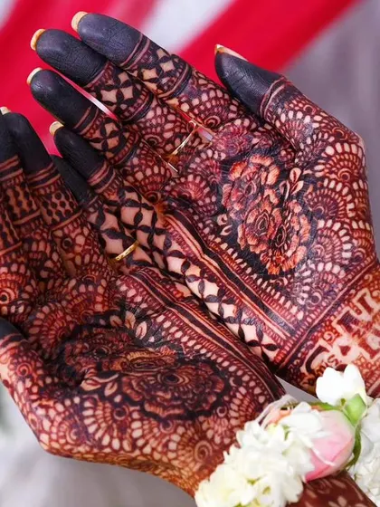 The stunning result of an engagement mehndi. The deep, dark stain on the fingers and palms looks absolutely beautiful.
