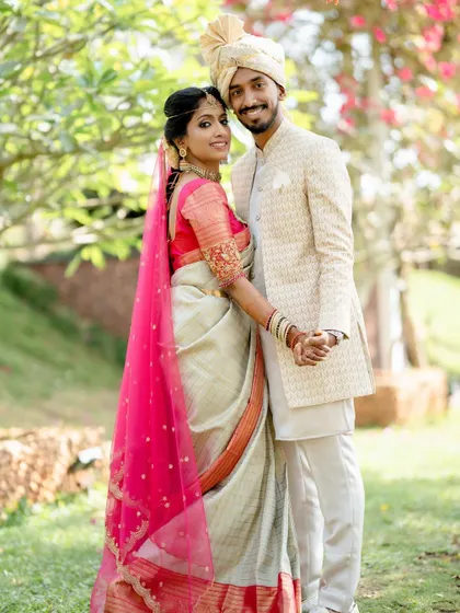 The flowing pink veil adds a touch of drama and romance to Sushma's traditional bridal saree.