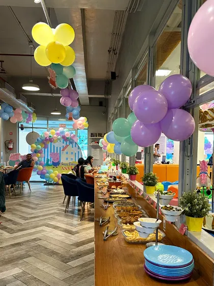 This is the view from our cafe during a Peppa Pig party. Parents can comfortably sit, eat, and chat while keeping an eye on the kids playing just a few feet away.