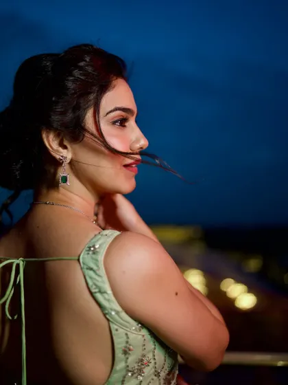 A back profile shot capturing the wind in my hair, adding a touch of romance to this ethereal green saree look.
