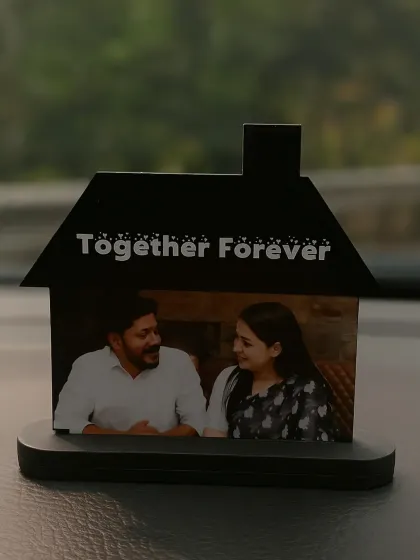 A personalized car dashboard decor piece. This hut-shaped stand holds a couple's photo and the text 'Together Forever.'
