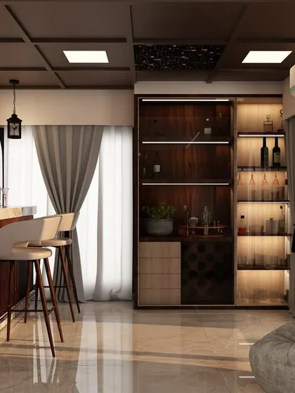 A custom home bar setup integrated into the living area, complete with stylish bar stools, ample bottle storage, and dramatic pendant lighting for entertaining guests.