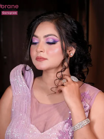 A beautiful portrait showcasing the intricate floral details on the gown and the complementary purple eye makeup.