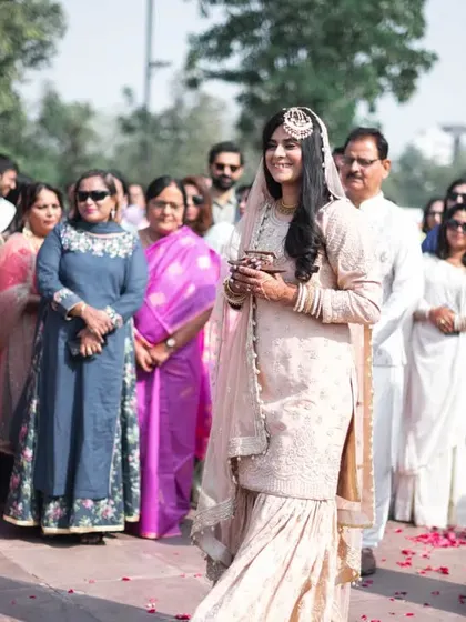 The bride, surrounded by her family, looking on with anticipation.