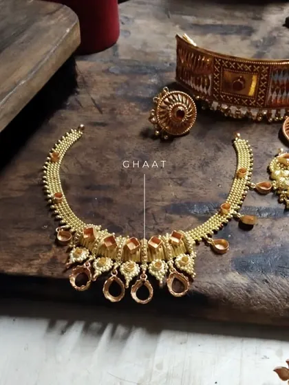 The 'ghaat' or structural framework of a necklace being redesigned. This behind-the-scenes shot shows how we arrange the old gold pieces before adding stones and finishing touches.