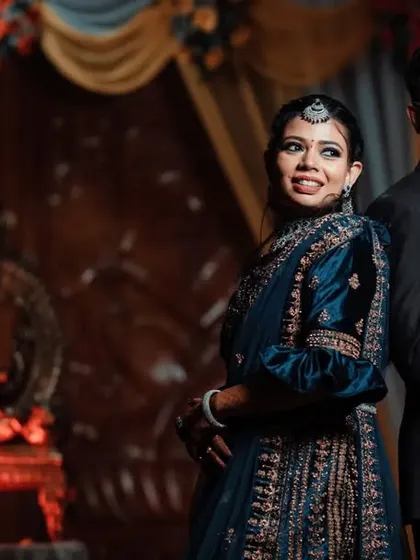 A stylish portrait of a couple at their reception. We use dramatic lighting to create a sophisticated and elegant look for your evening event photos.
