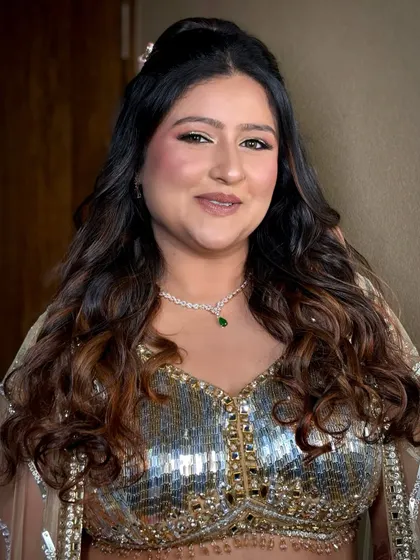 A smiling portrait of the bride, looking confident and beautiful for her sangeet night.