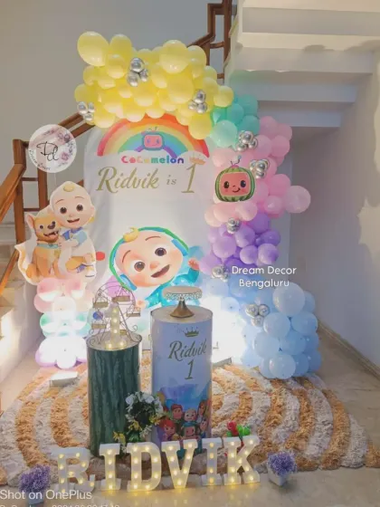 Another take on the Cocomelon theme, this time with a pastel rainbow balloon arch. This setup is perfect for smaller spaces, using vertical height to create a big impact with custom plinths for the cake.