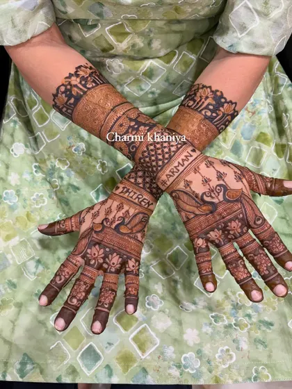 A lovely design with the couple's names, Shiren and Arman, written on the arms. The hands are adorned with classic peacock and lotus motifs, making it personal and traditional.
