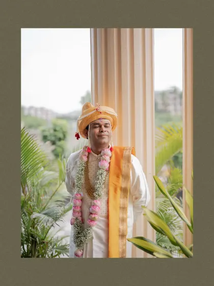 A serene portrait of the groom in his traditional Maharashtrian wedding attire, with his eyes closed as if soaking in the moment.
